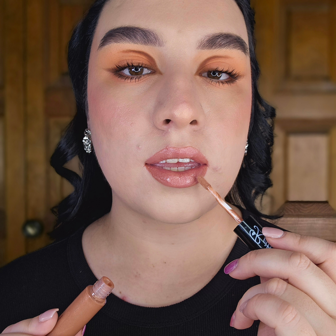 Woman with fair skin wearing Reillie Beauty Organic Lip Gloss in Caramel, warm caramel shimmering shade with nourishing botanicals