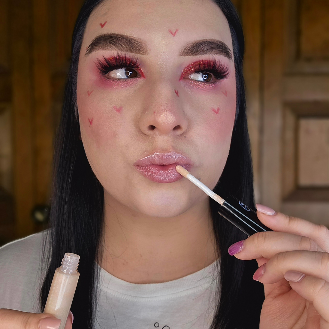 Woman with fair skin wearing Reillie Beauty Organic Lip Gloss in Creamy Vanilla, clear shimmering shade with nourishing botanicals