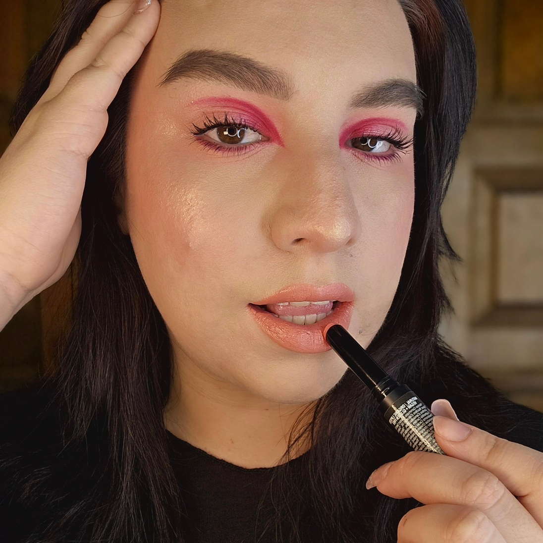 Woman with fair skin applying Reillie Beauty Organic Lipstick in Hyacinth, soft orange shade with nourishing botanicals