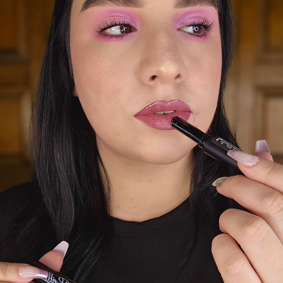 Woman applying Reillie Beauty Organic Lipstick in Wisteria on lips, soft purple shade with nourishing botanicals