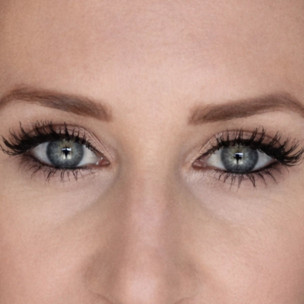 Close-up of a person's eyes with detailed focus on the eyelashes and skin texture.