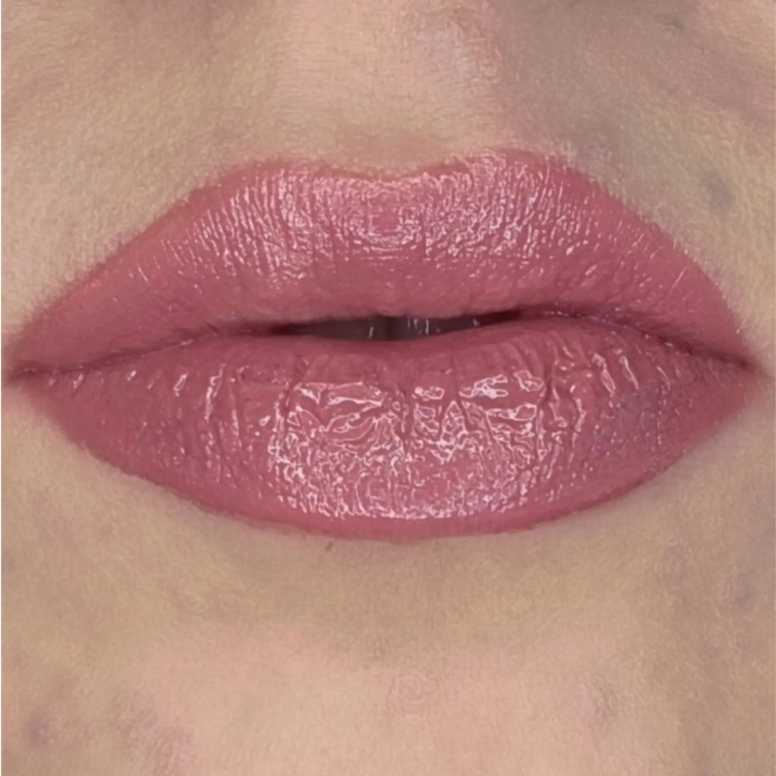 Woman with fair skin wearing Berry glow Gloss shade with nourishing botanicals