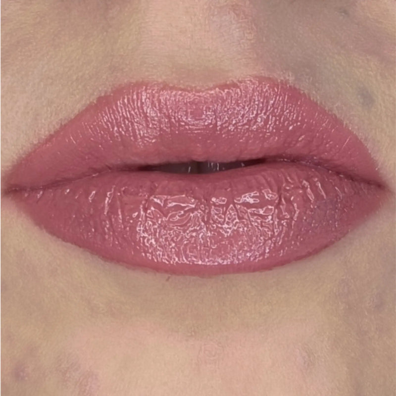 Woman with fair skin wearing Berry glow Gloss shade with nourishing botanicals
