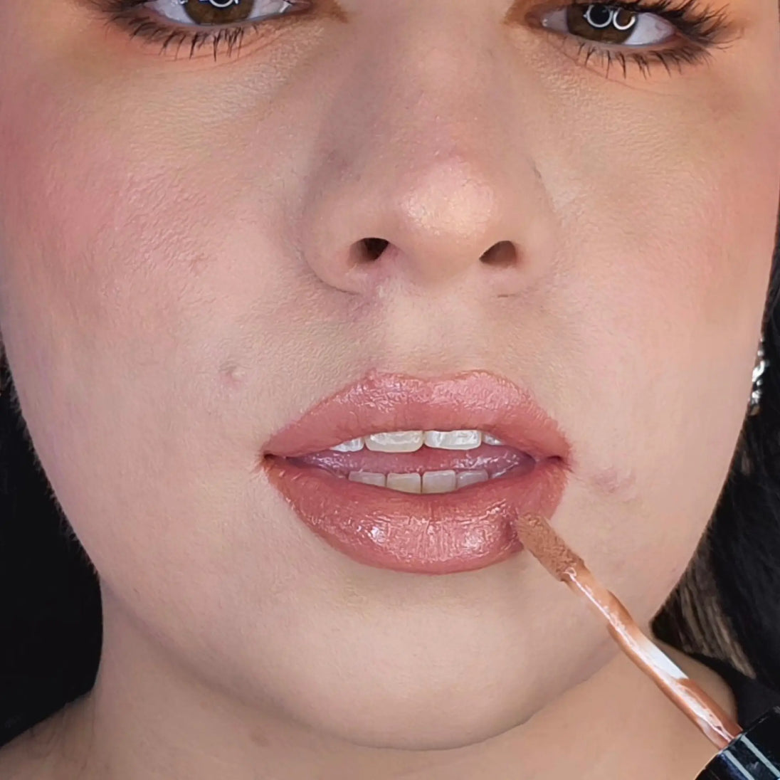 Woman with fair skin wearing Caramel Lip Gloss, warm brown shimmering shade with nourishing botanicals
