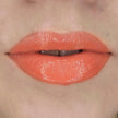 Woman with fair skin wearing Cinnamon Lip Gloss, clear shimmering shade with nourishing botanicals