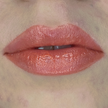 Woman with fair skin wearing Cinnamon Lip Gloss, clear shimmering shade with nourishing botanicals