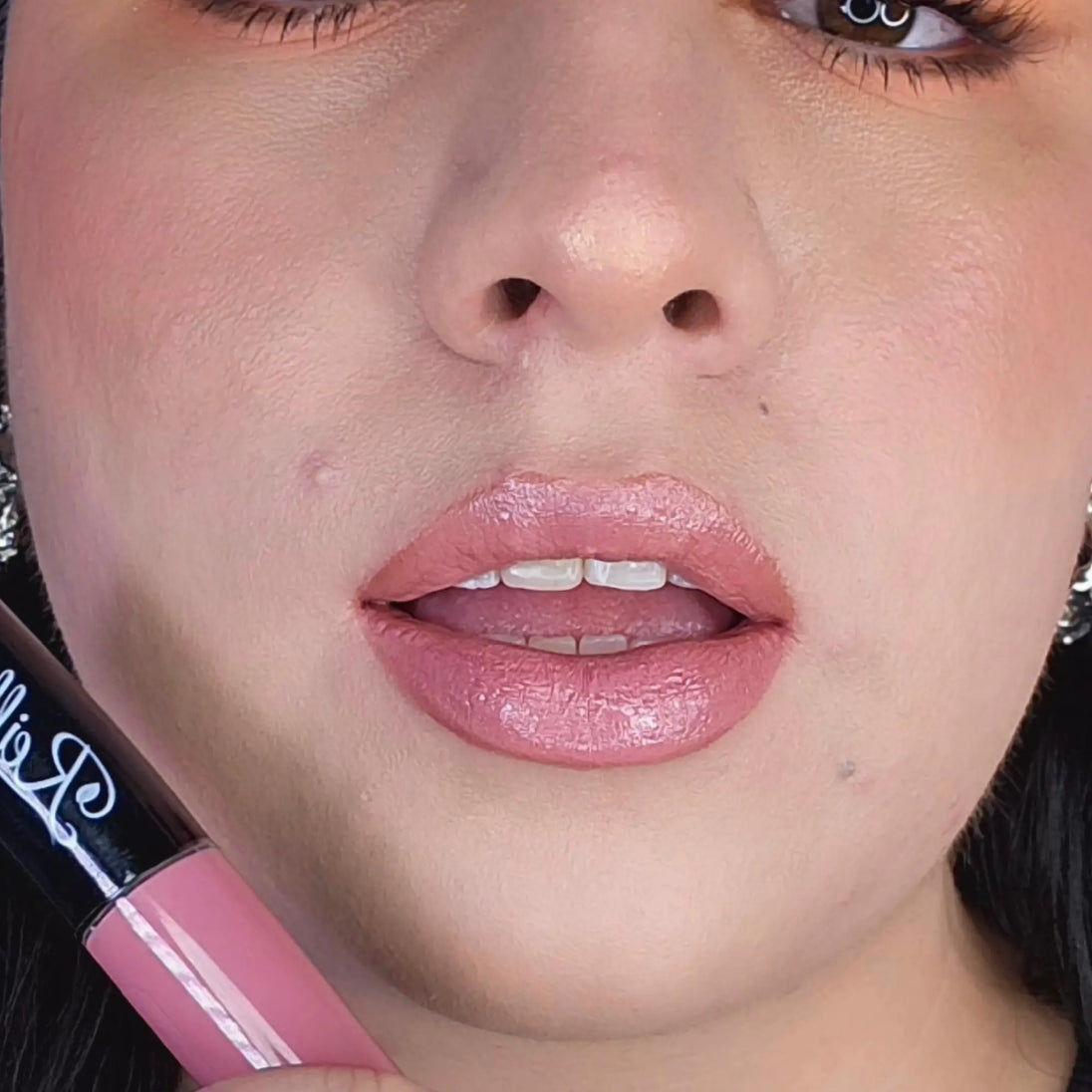 Woman with fair skin wearing Luscious Guava Lip Gloss, soft pink shade with nourishing botanicals
