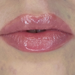 Woman with fair skin wearing Sugar Veil Lip Gloss, clear shimmering shade with nourishing botanicals