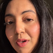 A close-up portrait of a woman wearing tint captured in warm, direct sunlight.