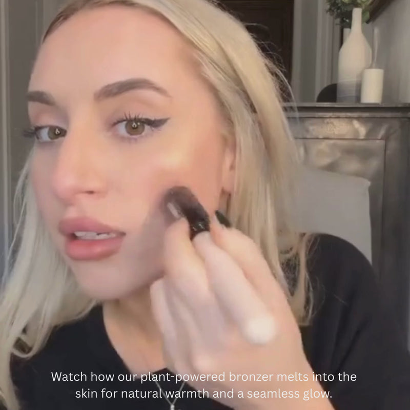 Woman applying Reillie Beauty Organic Bronzer in Topaz on face,