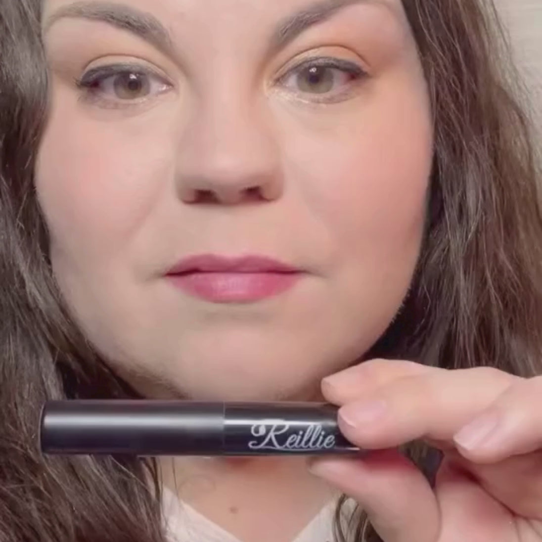 Woman with fair skin wearing Daylily Lipstick, red shade.