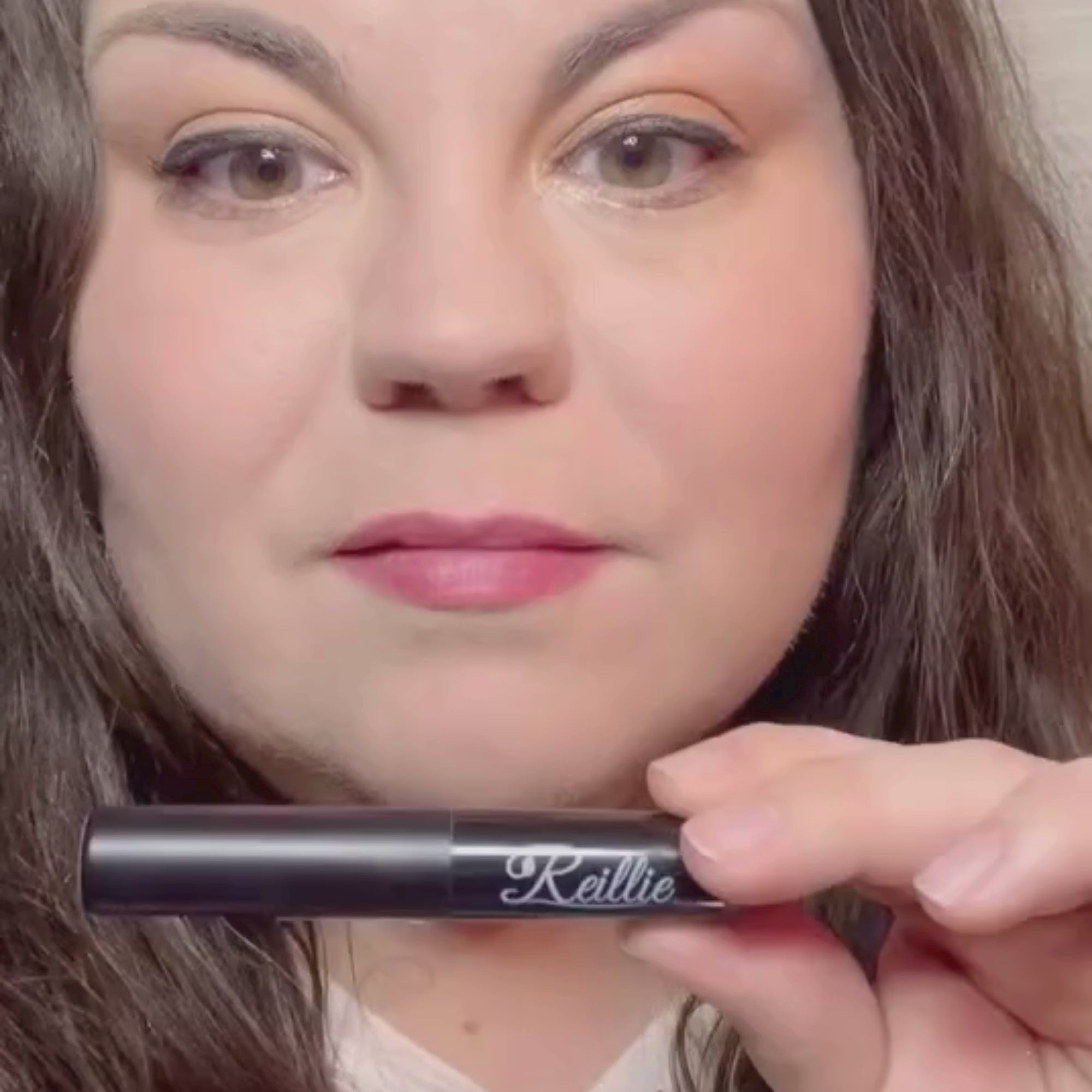 Woman with fair skin wearing Daylily Lipstick, red shade.