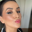 Woman applying Reillie Beauty Organic Bronzer in Topaz on face, warm golden-brown shade for natural glow