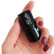 Reillie Beauty Amber Highlighter Tint in compact tube held by hand