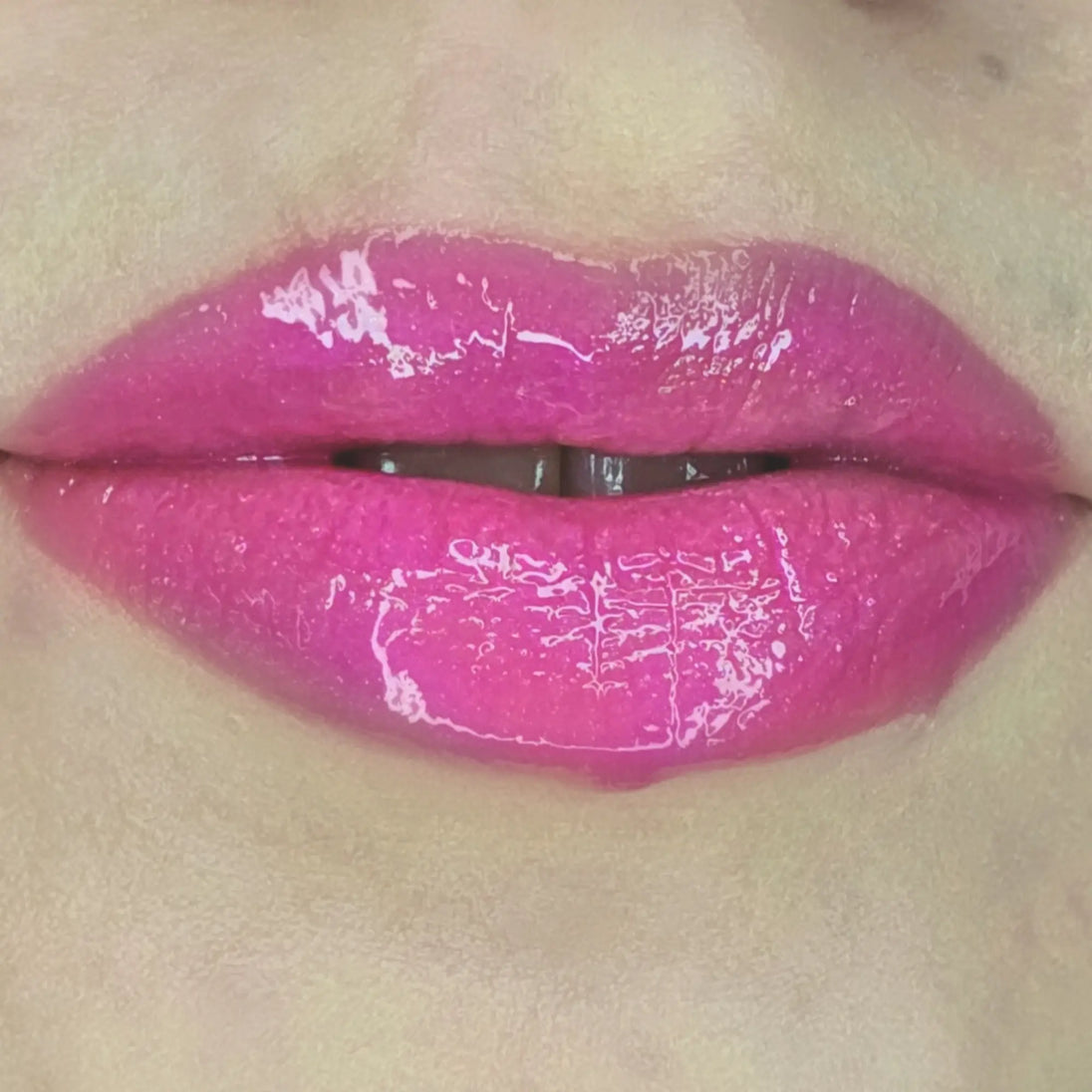 Woman with fair skin wearing Dragon fruit Gloss, clear shimmering shade with nourishing botanicals