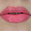 Woman with fair skin wearing Luscious Guava Lip Gloss, clear shimmering shade with nourishing botanicals