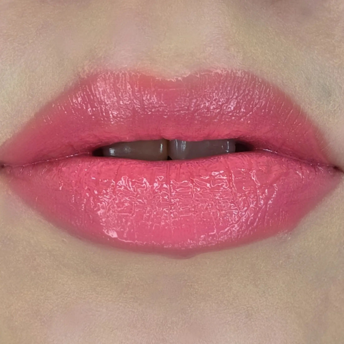 Woman with fair skin wearing Luscious Guava Lip Gloss, clear shimmering shade with nourishing botanicals