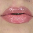 Woman with fair skin wearing Creamy Vanilla Lip Gloss, clear shimmering shade with nourishing botanicals
