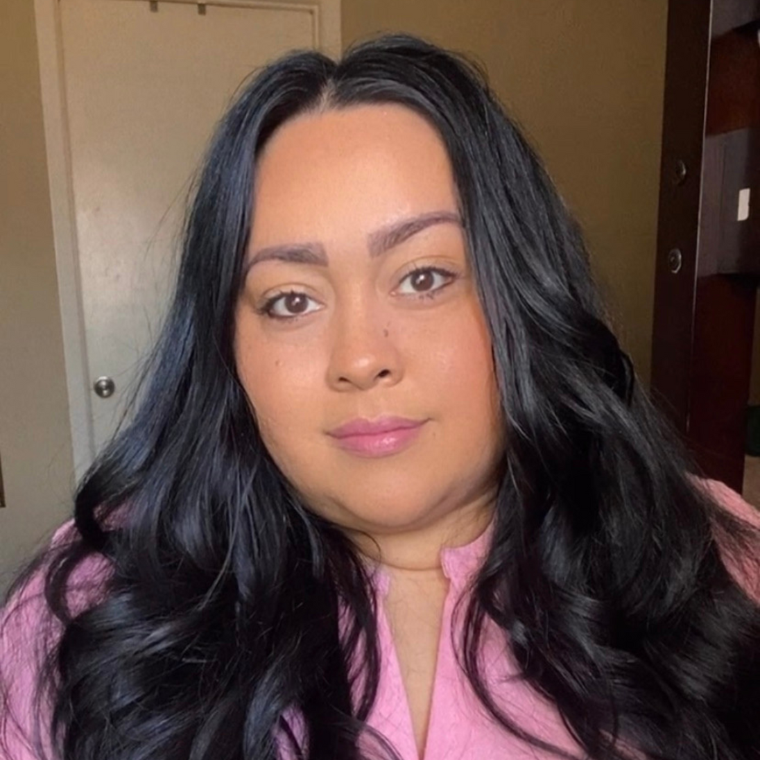 Reillie Beauty Luscious Guava Lip Gloss applied on lips of deep skin, soft pink and glossy

