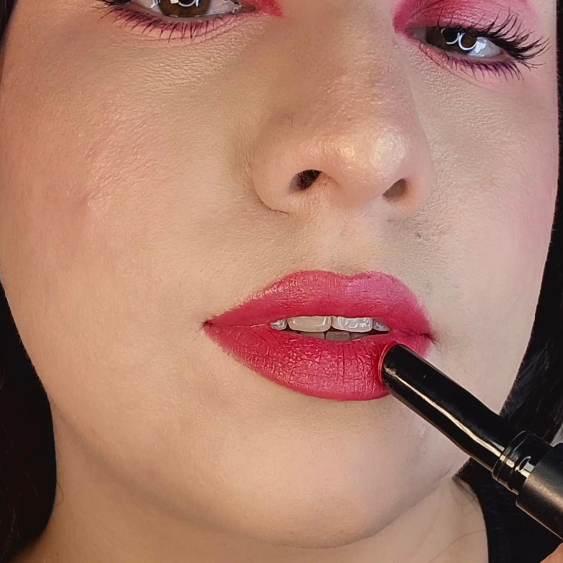 Woman with fair skin wearing Daylily Lipstick, red shade with nourishing botanicals