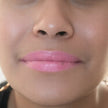 woman with medium skin wearing Peony Lipstick, soft pink shade with nourishing botanicals