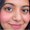 Close-up of a woman's face with dahlia color blush on cheeks