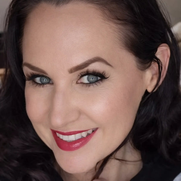 Close-up of a woman with rose petal tint.