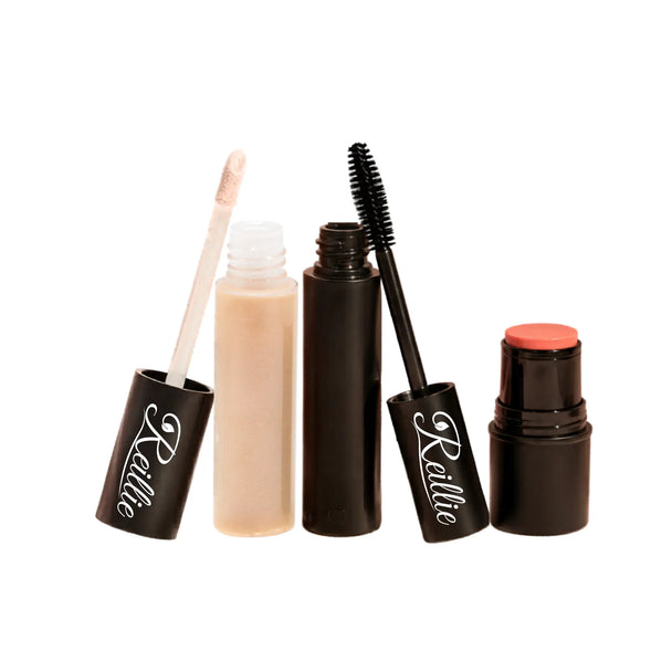 Set of makeup products including a lip gloss, mascara, and tint on a white background