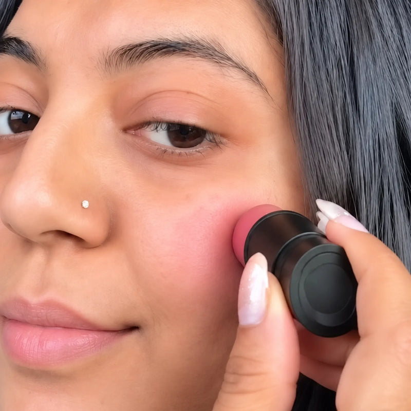 woman applying tint over her cheek